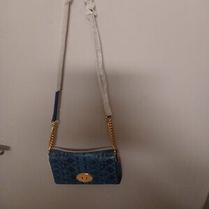 Coach. This is a beautiful cross over or clutch coach bag